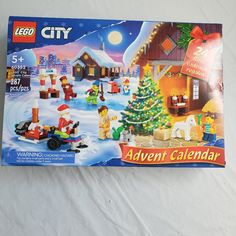 a lego city christmas calendar is displayed on a white surface