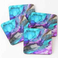 three coasters with blue and purple designs on them