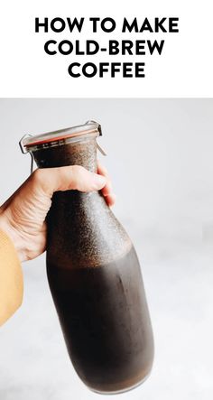 a person holding a coffee bottle with the words how to make cold - brew coffee