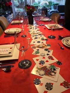 the table is set with cards and place settings