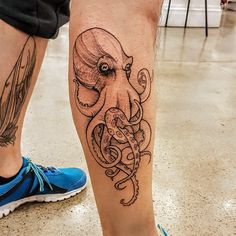 an octopus tattoo on the leg of a man