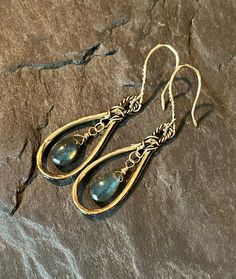 These beautiful, bohemian style dangles feature handcrafted, artisan, gold bronze hoops, with smooth, blue flash labradorite gemstones. The gems are wire wrapped in gold filled wire. The gorgeous ear wires are handcrafted in gold bronze. Total length is approximately 2 inches.  Earrings will arrive in a gift box.  Please ensure that your correct address is listed when you place your order. Terra Glass and Gems is not responsible for lost, stolen, damaged, or misplaced packages. Labradorite Earrings, Wire Jewelry, Ear Wires, Wire Wrapped, Boho Style, Favorite Jewelry, Labradorite, Jewelry Earrings Dangle, Bohemian Style