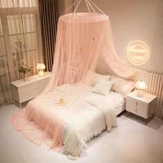 a bed with a pink canopy over it