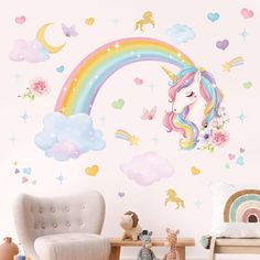 a child's room with a rainbow wall decal and unicorn toys on the floor