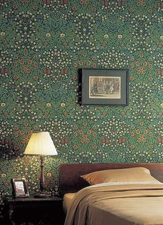 an image of a bedroom setting with green wallpaper and floral pattern on the walls