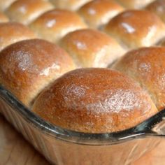 bread rolls in a glass baking dish on a wooden table