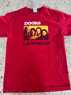 Vintage The Doors LA Woman T Shirt  Size Medium but see pics for measurements. May fit small  Quality 100% Cotton  Awesome Graphic of band members  Song: L.A. Woman written by John Densmore, Robby Krieger, Ray Manzarek, Jim Morrison | SecondHandSongs. Fine condition  Quick shipping   We ship same or next day with USPS mail  We are a small family business and we appreciate your purchase, Godspeed ! Band Logo T-shirt For Concert, Red Band Merch Top With Logo, Red Band Logo T-shirt With Crew Neck, Red Graphic Tee With Band Logo, Red Band Logo Graphic Tee, Casual Red T-shirt With Band Logo, Red Short Sleeve Tops With Band Logo, John Densmore, Robby Krieger