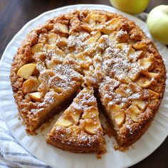 an apple pie on a white plate with one slice cut out