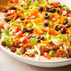 a white bowl filled with taco salad on top of a table