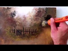 a man is painting a landscape with orange paint