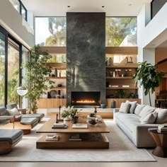 a living room with couches, tables and a fire place in the middle of it