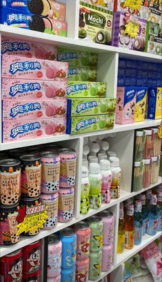 the shelves are filled with many different types of drinks and confection items for sale