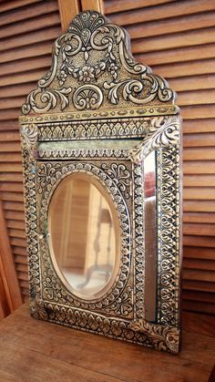 a mirror sitting on top of a wooden table