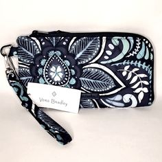 New! Rfid Protected Phone Wristlet With Zip Closure. Interior Features Four Card Slots And Slip Pocket For Phone With Clear Touch Screen Window. Detatchable Wrist Strap. Brand: Vera Bradley Pattern: Blue Island Medallion Measurements: 8"L X 4.5"H X 0.5"W Posh Ambassador Top Rated Seller Fast Shipper Reasonable Offers Accepted Vera Bradley Blue Island Medallion, Phone Clutch Wallet, Embroidered Clutch Purse, Screen Window, Vera Bradley Patterns, Phone Wristlet, Embroidered Clutch, Black Wristlet, Metal Straps