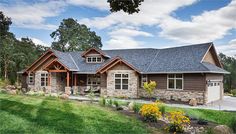 a large house with stone and wood accents