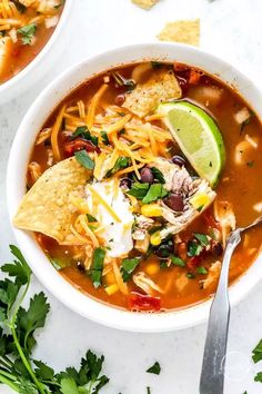 two bowls of mexican chicken soup with tortilla chips