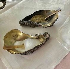 two oysters on a table with salt and pepper in them