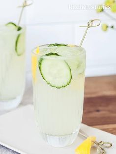 two glasses filled with cucumber and lemonade