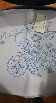 a blue and white table cloth with an image of a bird in flight on it