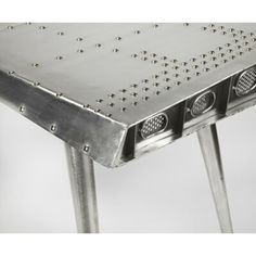 a metal table with holes and rivets on it