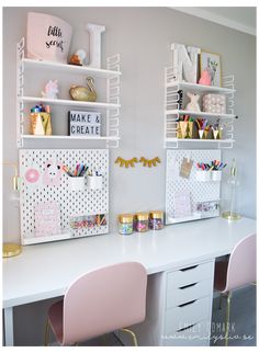 two desks with pink chairs and white shelving on the wall in a girls'room