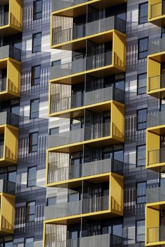 an apartment building with balconies and yellow balconies