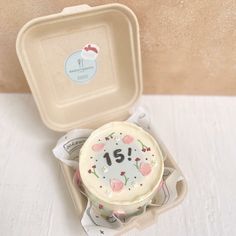 a cake in a box with the number fifteen on it's front and side