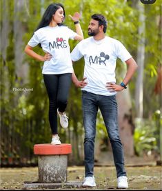 a man and woman standing next to each other wearing matching shirts that say mr and mrs