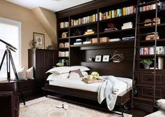 a bedroom with a bed, bookshelf and other items in the room around it