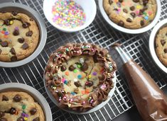 chocolate chip cookie with sprinkles and other dessert items on a cooling rack