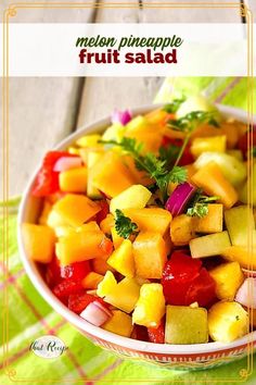 a white bowl filled with fruit salad on top of a table