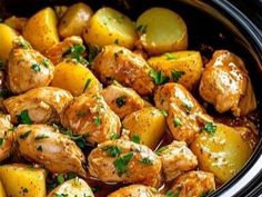 chicken and potatoes in the crock pot with parsley garnish on top