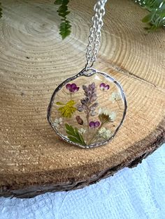 Handmade Epoxy resin necklace with real dried flowers. Made in the UK. Perfect and unusual gift idea. Comes beautifully presented in a gift box. Pendant material - alloy, hypoallergenic. Chain material:  sterling silver, silver plated, lightweight.  Stay close to nature with this necklace. Perfect happy summer necklace with bright colours flowers. Perfect anniversary, birthday or leaving gift.  Clover flower The meaning and symbolism of clover flowers are closely associated with good fortune and Bohemian Silver Necklaces With Pressed Flowers, Bohemian Clear Jewelry As A Gift, Delicate Sterling Silver Necklace With Pressed Flowers, Pressed Flowers Keepsake Jewelry, Handmade Clear Flower Necklace, Clear Flower Pendant Necklace As Gift, Delicate Pressed Flower Necklace Gift For Her, Unique Pressed Flower Necklace, Clear Flower Pendant Necklace For Gift