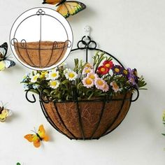 a hanging basket with flowers and butterflies on it