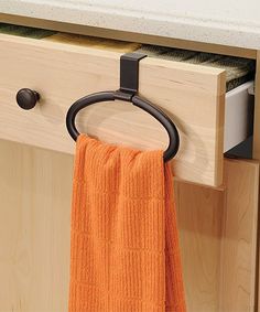 an orange towel hanging from a hook on a cabinet