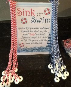 some red white and blue string on top of a black counter next to a sign that says sink or swim