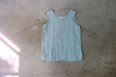 90s gorgeous FLAX linen tank top. Oversized. Very pale mineral green color. Very nice quality fabric - nice and airy.  Tag Size: Women's Medium - runs oversized. bust: 40" | length: 25"  Material: Linen Condition: Very Nice, a few very light yellow marks. All items are preloved + may show natural light signs of wear. Larger flaws will be noted. Visit our SISTER SHOP: www.etsy.com/shop/dirtybirdiesvintage Mineral Green, Linen Tank Top, Linen Tank, Cut Loose, Sleeveless Blouse, Linen Shirt, Favorite Things Gift, Womens Tank, Womens Clothing Tops