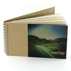 an open book with the road trip on it's cover is sitting in front of a white background