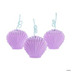 three purple seashells hanging from string on white background