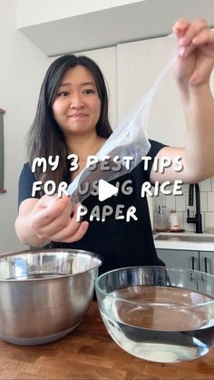 a woman holding up a plastic bag in front of a mixing bowl with ingredients on the counter