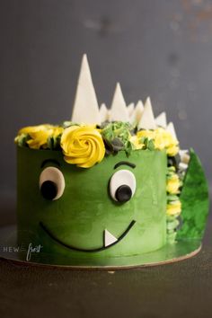 a green cake with yellow flowers on top