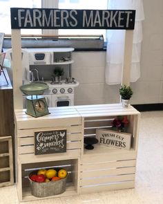 a store display with fruits and vegetables on it's shelves in front of a sign that says farmers market