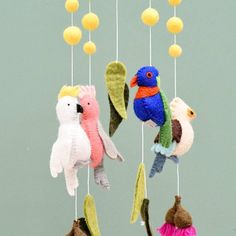 three small stuffed birds hanging from strings