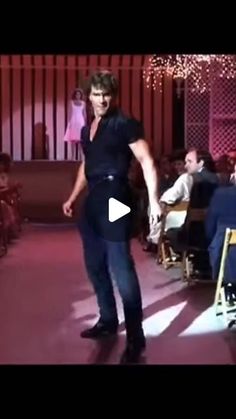 a man is dancing on the runway in front of people