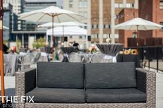 an outdoor seating area with umbrellas and tables in the backgroung behind it