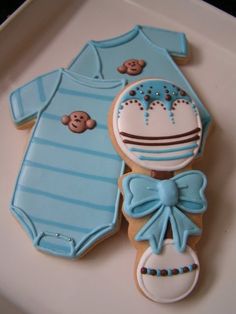 cookies decorated like baby clothes and teddy bears