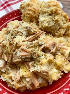 a red plate topped with mashed potatoes and meat