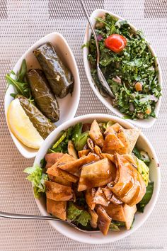 two bowls filled with food sitting on top of a table