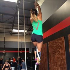 The Invictus Women's Workout Green racerback tank top with Invictus across chest and red V on the back - $20.