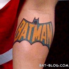 a batman tattoo on the arm of a man